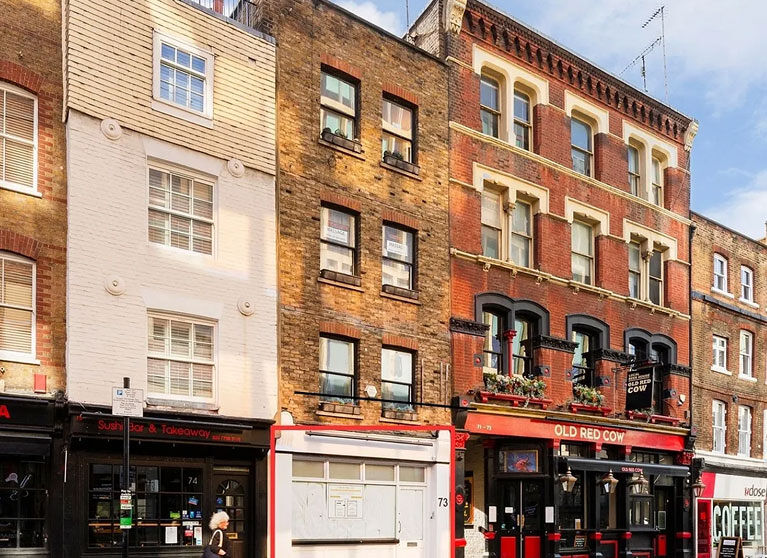 Period terrace in Shoreditch with shops and a pub at street level